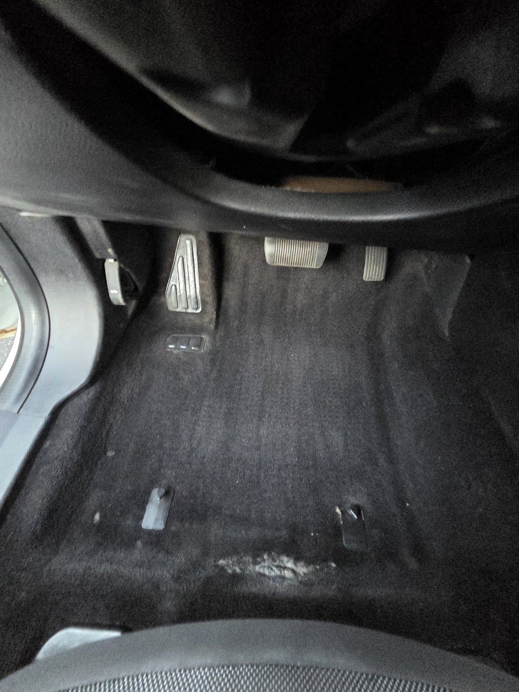 Driver side floor after dry cleanup with the floor mat still removed.