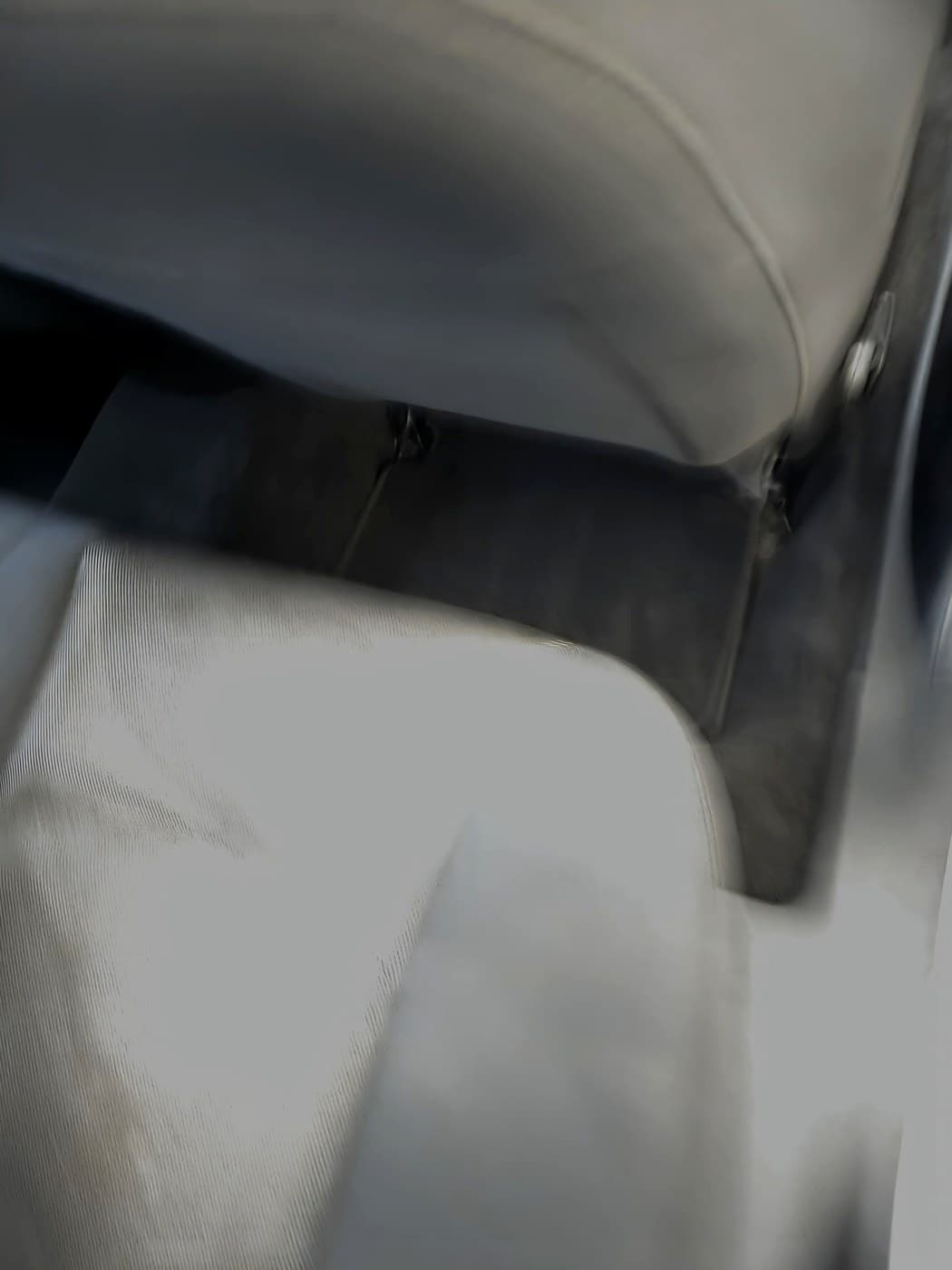 Rear passenger floor after cleanup with the floor mat back in place, shown in a real job photo.